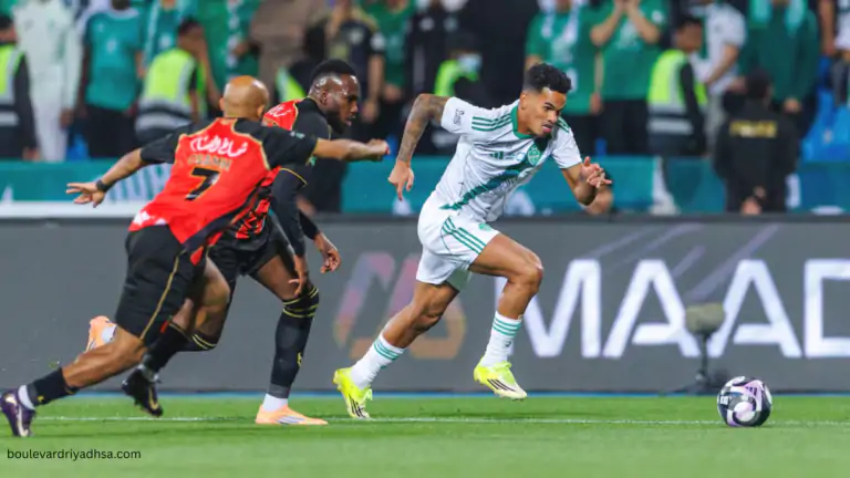 Al Ahli player dribbles past Al Qadsiah defenders during a Saudi Pro League 2026 match in Riyadh